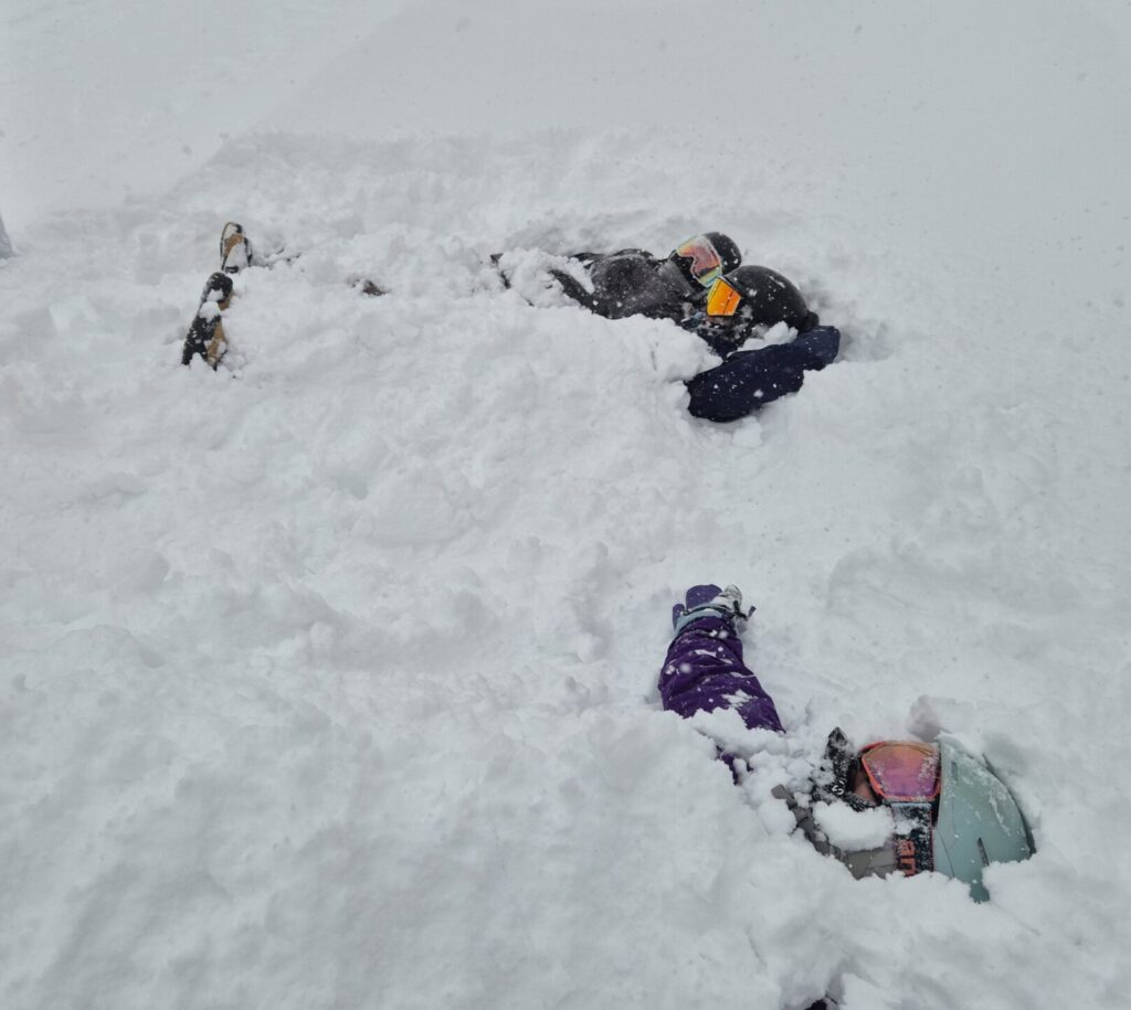Women skiers buried in deep January powder snow during a Women on Edge ski holiday in Niseko, Japan.